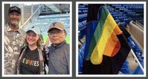 Three friends at a sports event and a bag with a rainbow flag draped over stadium seating.